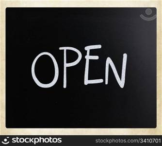 "The word "Open" handwritten with white chalk on a blackboard"
