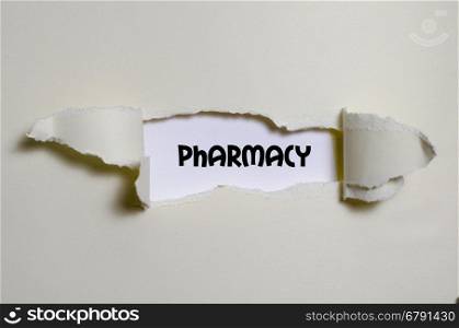 The word pharmacy appearing behind torn paper