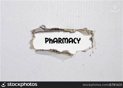The word pharmacy appearing behind torn paper