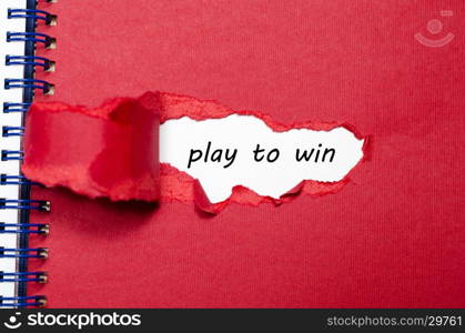 The word play to win appearing behind torn paper