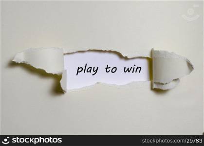 The word play to win appearing behind torn paper