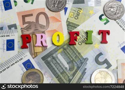The word profit is written on the banknotes.. The word profit.