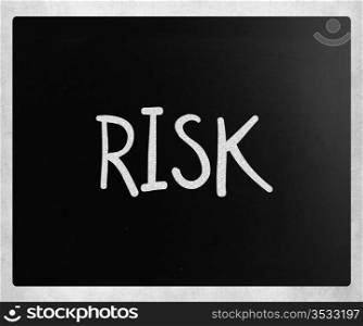 "The word "Risk" handwritten with white chalk on a blackboard"