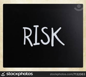 "The word "Risk" handwritten with white chalk on a blackboard"