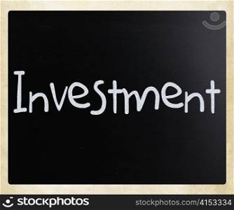 The word &rsquo;Investment&rsquo; handwritten with white chalk on a blackboard