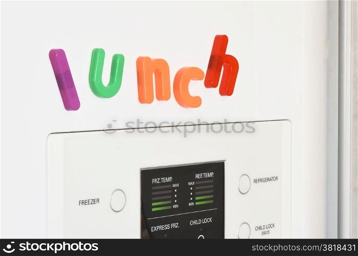 The word &rsquo;lunch&rsquo; spelled out in fridge magnets on the door of a fridge.