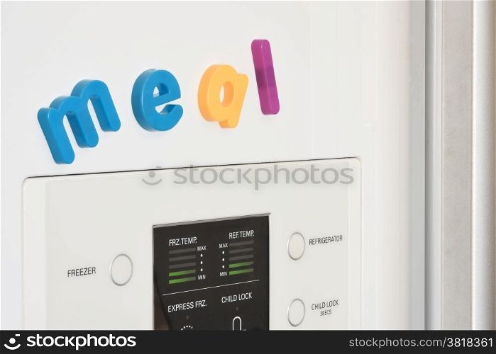 The word &rsquo;Meal&rsquo; spelled out in fridge magnets on the door of a fridge.