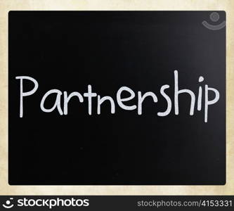 The word &rsquo;Partnership&rsquo; handwritten with white chalk on a blackboard
