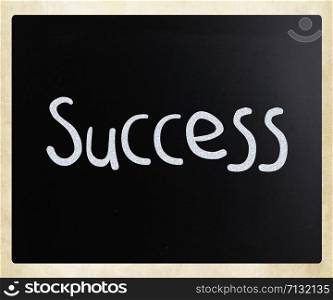 The word &rsquo;Success&rsquo; handwritten with white chalk on a blackboard
