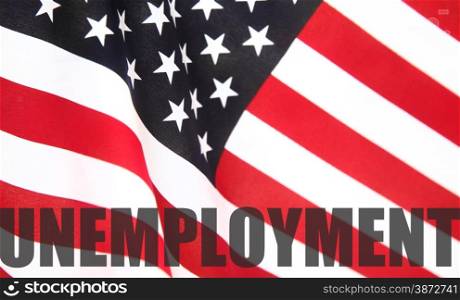 the word &rsquo;unemployment&rsquo; on a USA flag