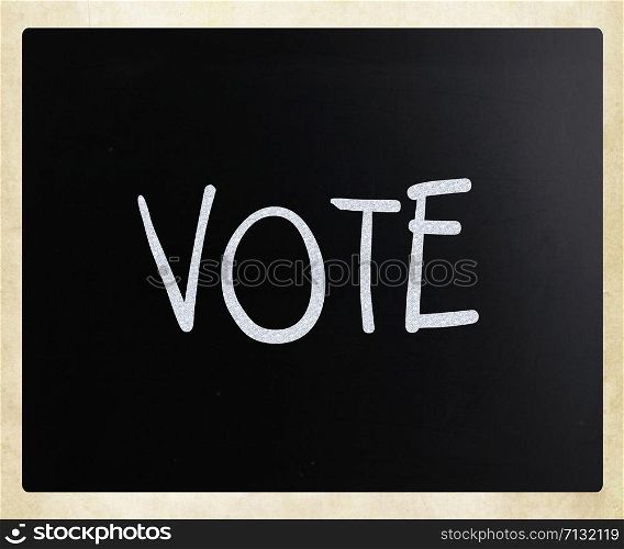 The word &rsquo;Vote&rsquo; handwritten with white chalk on a blackboard