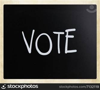 The word &rsquo;Vote&rsquo; handwritten with white chalk on a blackboard