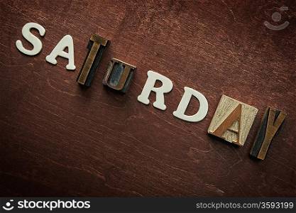 The word saturday written on wooden background
