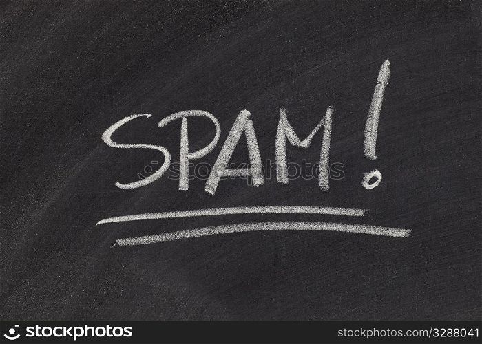 the word spam (unsolicited and unwanted commercial email messages) - white chalk handwriting on blackboard