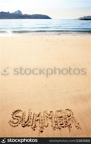 The word summer written in the sand at a beach