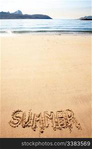 The word summer written in the sand at a beach