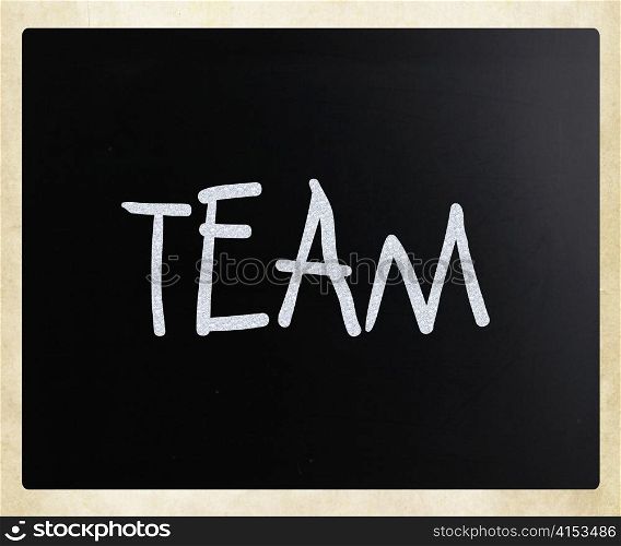 "The word "TEAM" handwritten with white chalk on a blackboard"