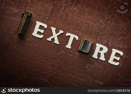 The word texture written on wooden background