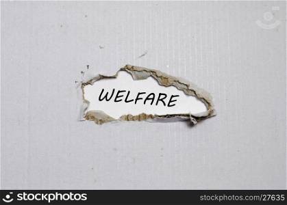 The word welfare appearing behind torn paper