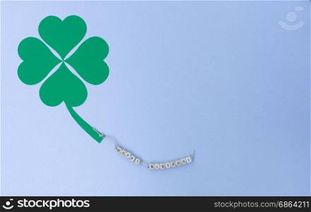 The words Happy Birthday on a cord and a cloverleaf