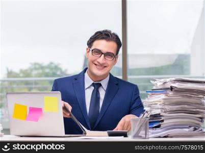 The workaholic businessman overworked with too much work in office. Workaholic businessman overworked with too much work in office