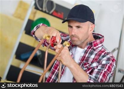 the worker fixes some metal pipe