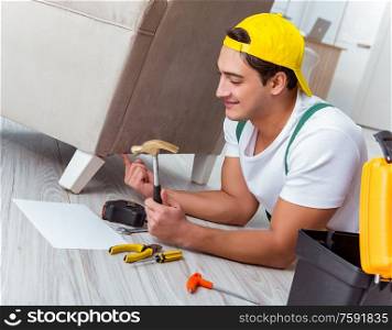 The worker repairing furniture at home. Worker repairing furniture at home