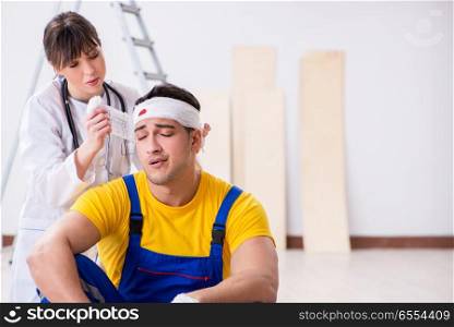 The worker with injured head and doctor. Worker with injured head and doctor