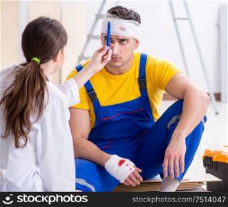 The worker with injured head and doctor. Worker with injured head and doctor