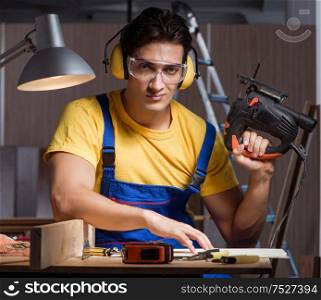 The worker working in repair workshop in woodworking concept. Worker working in repair workshop in woodworking concept
