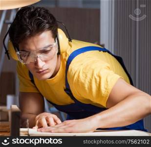 The worker working in repair workshop in woodworking concept. Worker working in repair workshop in woodworking concept