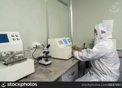 The workers in the workshop for the production and quality control of the internal parts of medical syringes. Workers in the workshop for the production and quality control of the internal parts of medical syringes