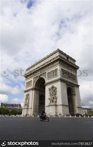The World Famous Arc de Triomphe on the Champs ?lisZe in paris with a three point perspective and a motor cyclist in front in slight motion blur.
