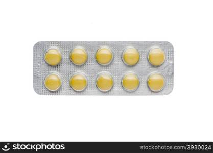 The yellow pills in a blister on isolated background. The yellow pills in a blister