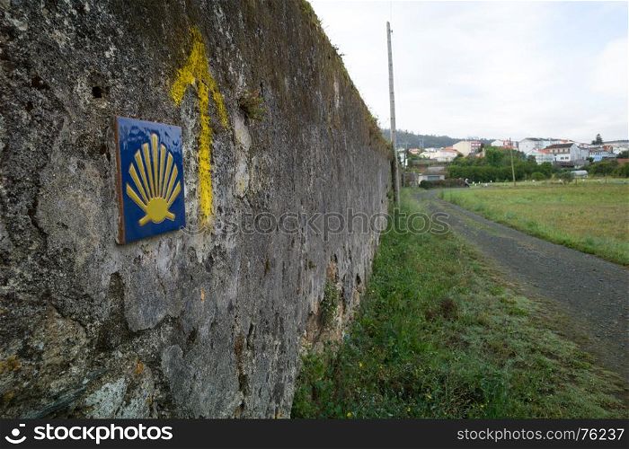 The yellow scallop shell signing the way to santiago de compostela