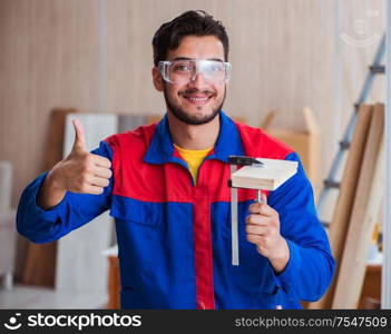 The yooung repairman carpenter working with paint painting. Yooung repairman carpenter working with paint painting