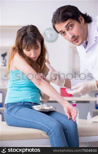 The young arm injured woman visiting young doctor traumatologist. Young arm injured woman visiting young doctor traumatologist