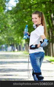 The young attractive girl in equipment with a water bottle