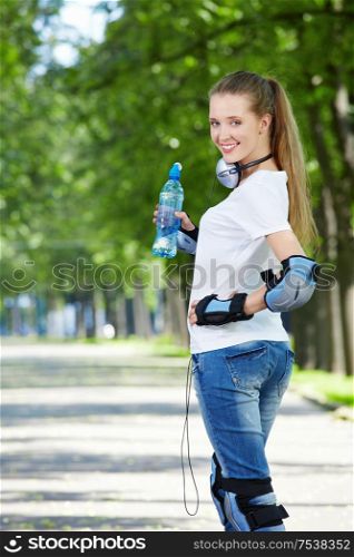 The young attractive girl in equipment with a water bottle