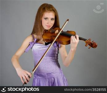 The young attractive girl with a violin