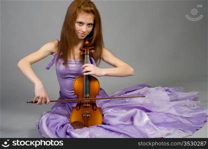 The young attractive girl with a violin