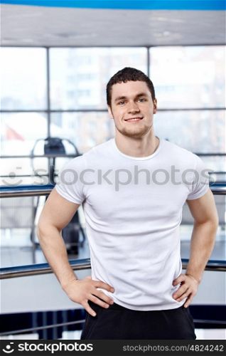 The young attractive man in sports hall
