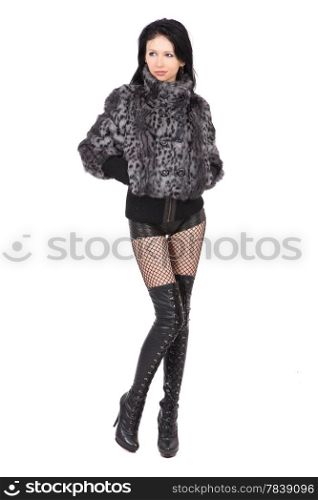 The young beautiful girl in a fur coat isolated on white