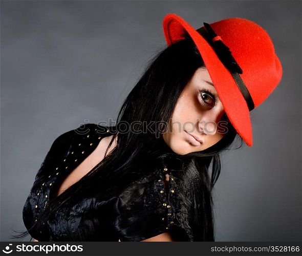 The young beautiful girl in a red hat