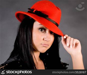 The young beautiful girl in a red hat