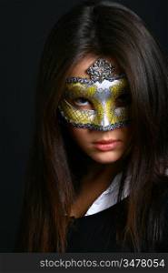 The young beautiful girl in mask looks at you