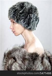 The young beautiful woman in a fur hat