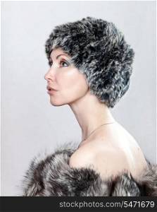 The young beautiful woman in a fur hat.