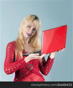 The young beautiful woman in red blouse with the red laptop