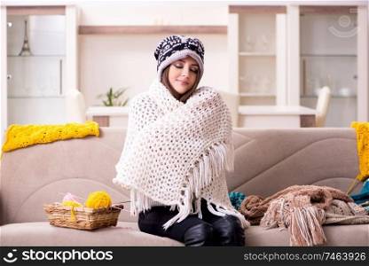 The young beautiful woman knitting at home. Young beautiful woman knitting at home